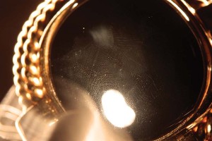 Only fibre-optic illumination was capable of revealing  the devitrification that proved the 'black onyx' in this pearl clasp was in fact glass.