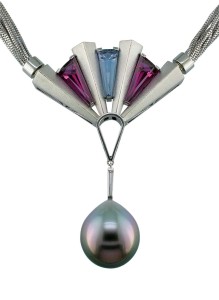 Art deco-inspired 'Fan Dance' pendant/claspÂ with matte-finish platinum set with tapered baguette suite of two rubellite tourmalines (2.20 ctw), 1.03-carat aquamarine, and tapered baguette diamond suspending a 15.4 x 13.8-mm South Sea pearl with rose and aqua overtones.