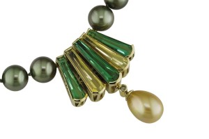 'Tierra' pendant clasp in 18-karat green gold set with green tourmaline, golden beryl, and accented with a yellow diamond and golden green South Sea pearl drop.