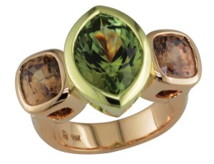 18-karat rose gold ring set with brown zircons centred with green tourmaline in 18-karat green gold.