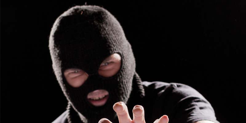 bigstock-Burglar-In-Mask-24156407