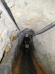 Our group walks through a 1.7-km (1-mi.) main tunnel in the Manantial Mine in Chivor, with ventilation tubes and electrical wires overhead.