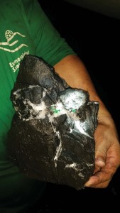 A miner holds up a sample of emeralds taken from the active face of the Cunas Mine.