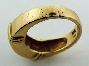 Although poor in quality, this yellow gold ring is an example of casting.  Note the telltale signs of cracking and pitting. 