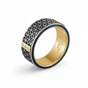 Comfort-fit, 8-mm carbon fibre wedding band with yellow gold inlay, topped with small screws on a golden plate, by Malo Bands. MSRP $1875