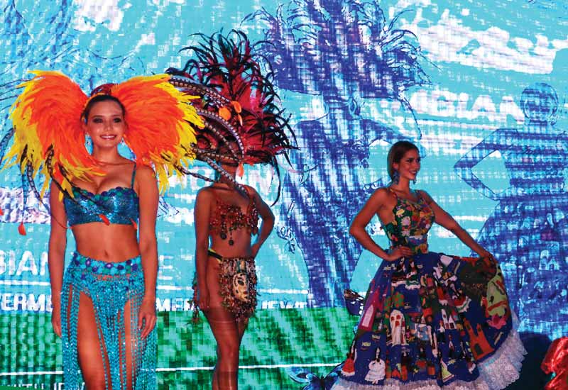 Models dressed in traditional Colombian attire wear emerald earrings during the gala dinner at the 2WES.