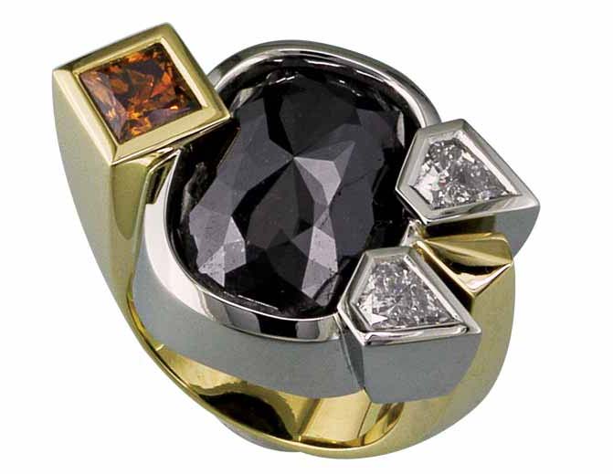 An 18-karat yellow gold and 19-karat white gold ring set with a 15.92-carat rose-cut black diamond centre stone, a 1.05-carat princess-cut natural fancy orange-brown diamond, and two kite-shaped white diamonds (0.93 ctw).