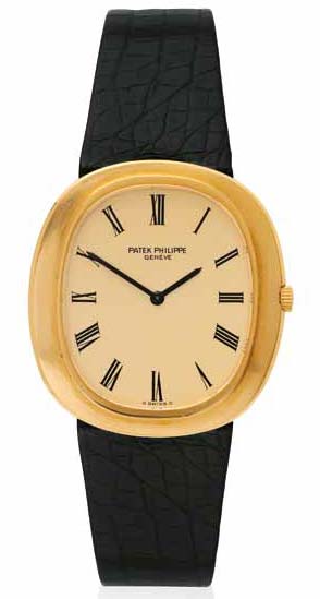 ‘Ellipse’ wristwatch by Patek Philippe featuring an automatic movement, cushion-shaped case with brushed-finish bezel, matte gilt dial, and black leather strap in 18-karat gold. Circa 1970.