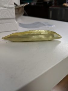 The pea pod boat was prototyped in resin, then cast in 18-karat green gold.