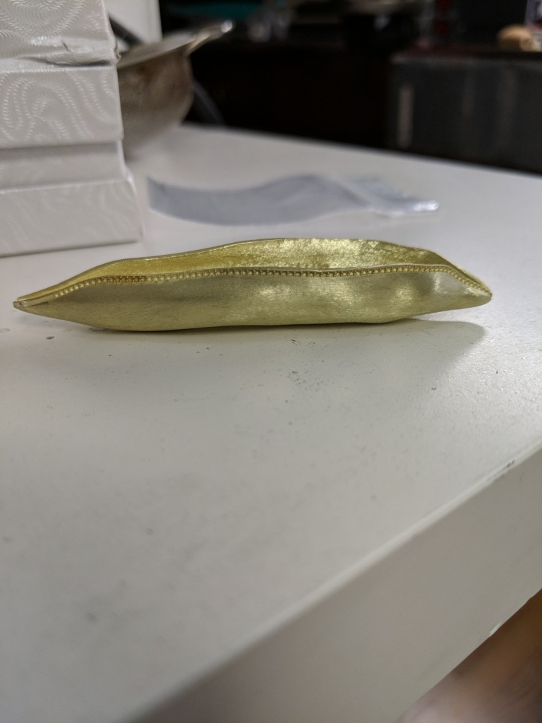 The pea pod boat was prototyped in resin, then cast in 18-karat green gold.