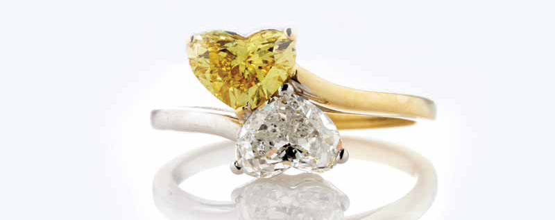 When it comes to engagement and wedding jewellery, clients often have preconceived ideas of what colour of gold is “right” for them. Perhaps, for instance, their mother, grandmother, and great-grandmother all had yellow gold wedding sets, and they are keen to carry on this tradition, or maybe they are drawn to the modern look achieved with white gold. In other cases, they may simply have go-to pieces—necklaces, bracelets, bands—they wear daily, and want to make sure their wedding jewellery harmonizes with these favourites. Regardless of the reasoning, deciding on the colour of gold often serves as a client’s point of departure when choosing engagement or wedding jewellery, particularly for colourless stones.