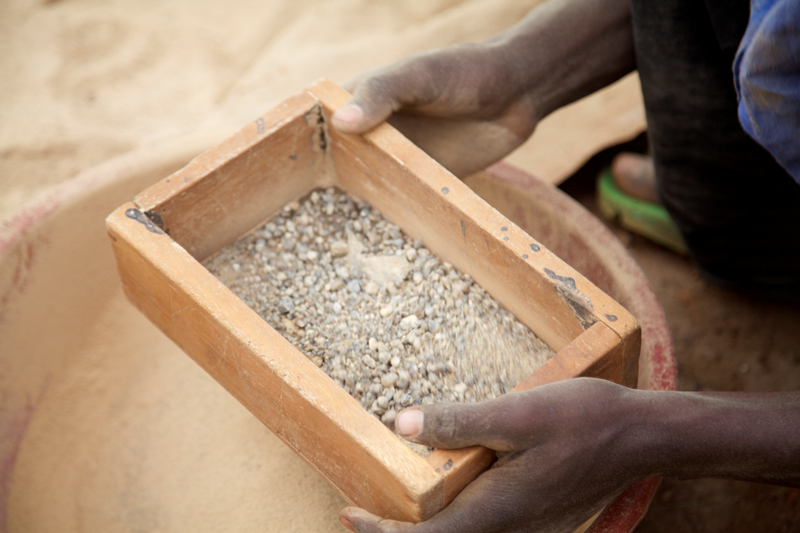 A Kenyan small-scale miner pans for gold.