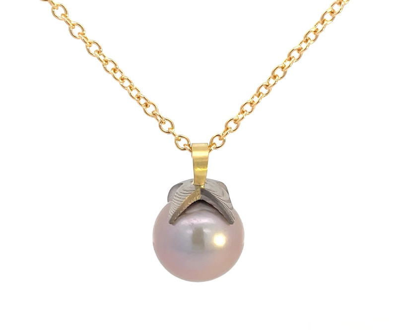 Pendant necklace by Chris Ploof, featuring a 14.5-mm natural colour pearl with a hand-forged Damascus cap, 18-karat gold bail, and 18-karat gold chain. MSRP US$1,865 for 18-karat chain (US$770 for stainless steel)