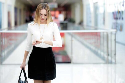 Woman checks her watch.