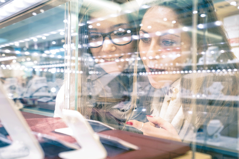 Women looking at jewellery display 